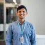 Young man looking at camera smiling, man in business, education, smiling, stability